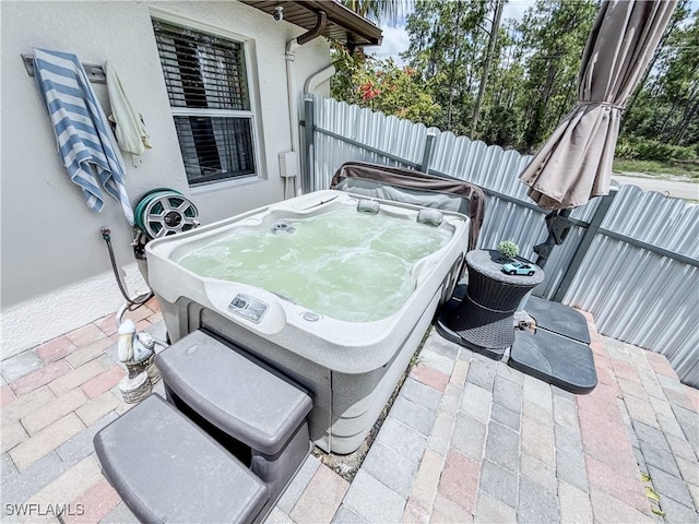 1700 E 15th St, Lehigh Acres, FL 33972 - view of patio / terrace featuring a hot tub