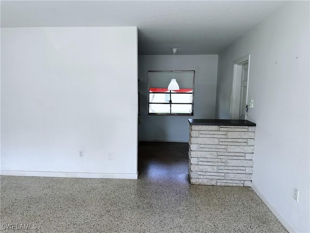 4360 Deleon St, Fort Myers, FL 33901 - unfurnished living room featuring speckled floor and baseboards