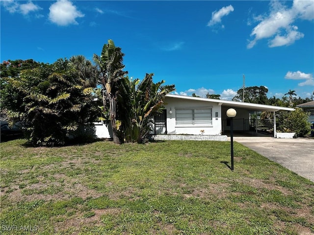 4360 Deleon St, Fort Myers, FL 33901 - view of front of property with an attached carport, a front lawn, concrete driveway, and stucco siding