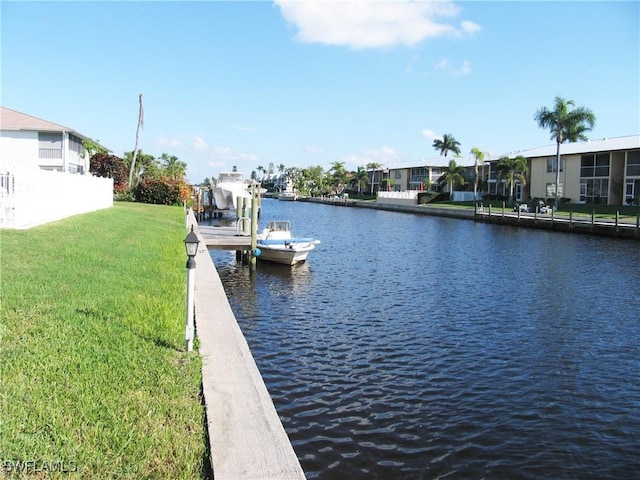 834 SE 46th St Unit 2A, Cape Coral, FL 33904 - dock featuring a water view and a lawn