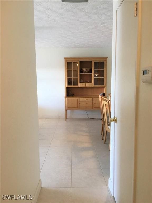 834 SE 46th St Unit 2A, Cape Coral, FL 33904 - corridor featuring light tile patterned flooring and a textured ceiling