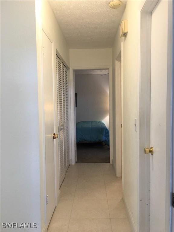 834 SE 46th St Unit 2A, Cape Coral, FL 33904 - hall with a textured ceiling and light tile patterned floors