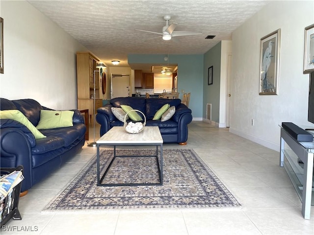 834 SE 46th St Unit 2A, Cape Coral, FL 33904 - living room with a ceiling fan, a textured ceiling, and light tile patterned flooring