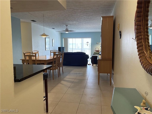 834 SE 46th St Unit 2A, Cape Coral, FL 33904 - dining room with ceiling fan, light tile patterned floors, and a textured ceiling