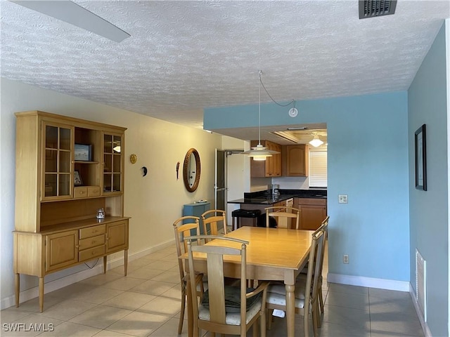 834 SE 46th St Unit 2A, Cape Coral, FL 33904 - dining area featuring light tile patterned flooring and a textured ceiling