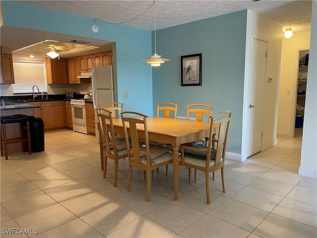 834 SE 46th St Unit 2A, Cape Coral, FL 33904 - dining area featuring light tile patterned floors, ceiling fan, and a textured ceiling