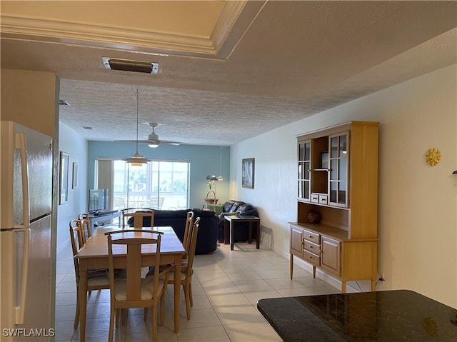 834 SE 46th St Unit 2A, Cape Coral, FL 33904 - dining area with a ceiling fan, light tile patterned floors, and a textured ceiling