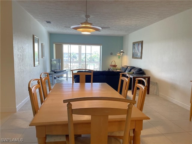 834 SE 46th St Unit 2A, Cape Coral, FL 33904 - dining space with healthy amount of natural light, a textured ceiling, light tile patterned floors, and ceiling fan