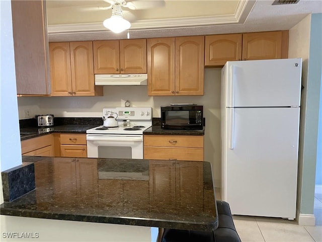 834 SE 46th St Unit 2A, Cape Coral, FL 33904 - kitchen with white appliances, under cabinet range hood, light brown cabinets, dark stone counters, and light tile patterned floors