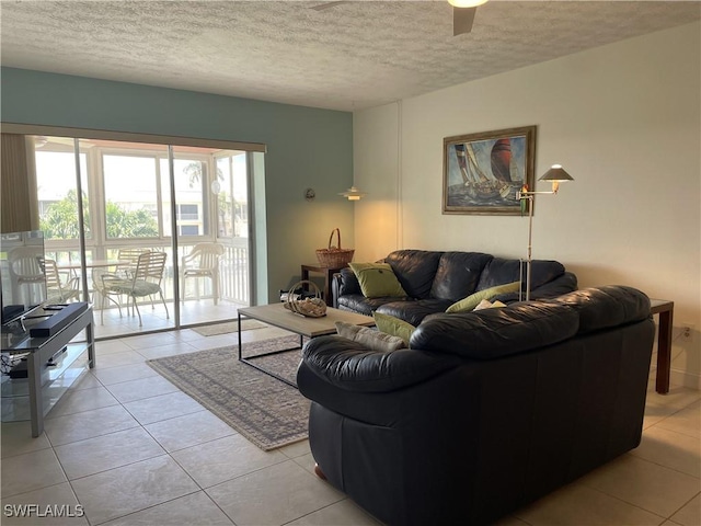 834 SE 46th St Unit 2A, Cape Coral, FL 33904 - living room with a textured ceiling, light tile patterned floors, and a ceiling fan