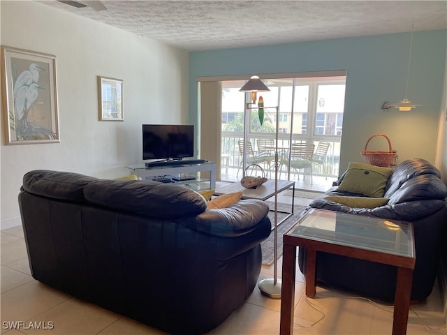 834 SE 46th St Unit 2A, Cape Coral, FL 33904 - living area featuring light tile patterned flooring and a textured ceiling