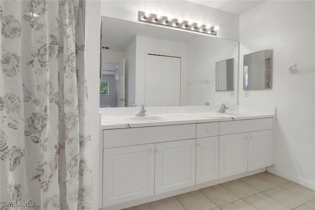 765 Aprile Ave S, Lehigh Acres, FL 33974 - full bathroom featuring double vanity and tile patterned floors