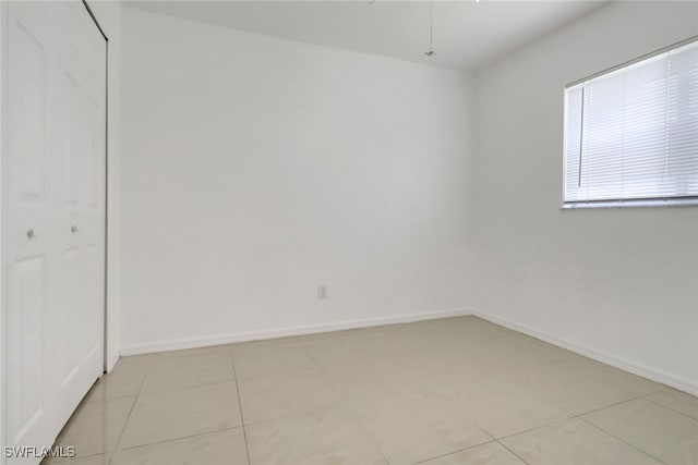 765 Aprile Ave S, Lehigh Acres, FL 33974 - unfurnished bedroom featuring light tile patterned flooring and a closet