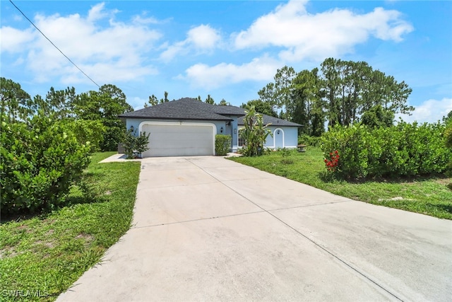 765 Aprile Ave S, Lehigh Acres, FL 33974 - view of front facade featuring a garage, driveway, stucco siding, and a front yard