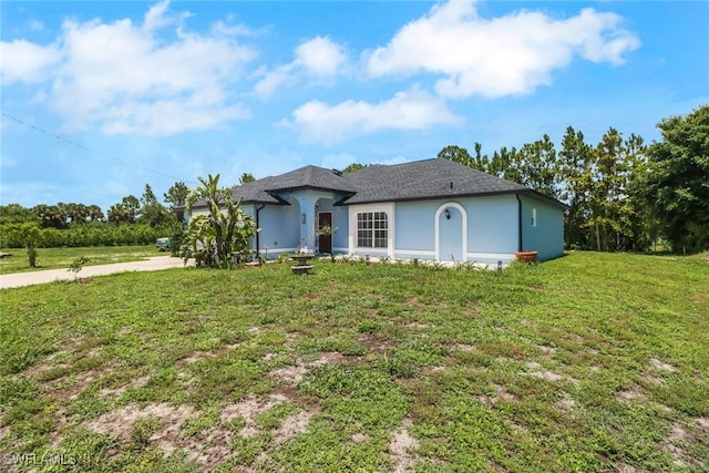 765 Aprile Ave S, Lehigh Acres, FL 33974 - view of front of property featuring a front yard and stucco siding