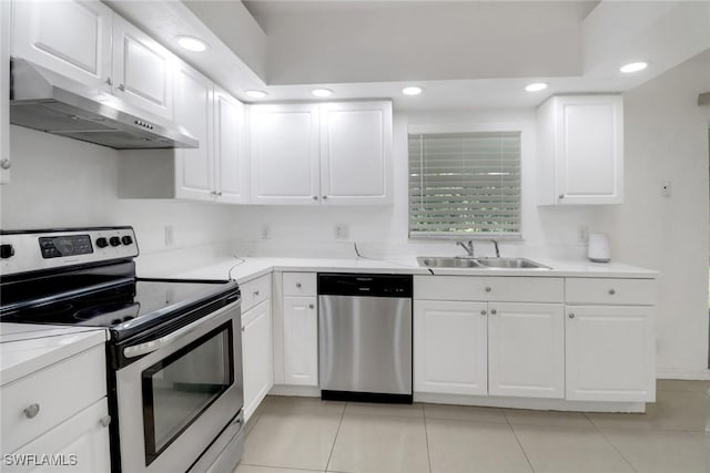 765 Aprile Ave S, Lehigh Acres, FL 33974 - kitchen featuring appliances with stainless steel finishes, under cabinet range hood, recessed lighting, light tile patterned floors, and white cabinets