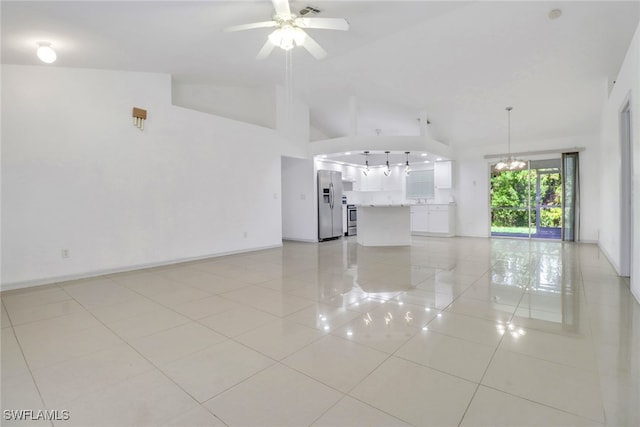 765 Aprile Ave S, Lehigh Acres, FL 33974 - unfurnished living room featuring light tile patterned floors, ceiling fan, a chandelier, and high vaulted ceiling