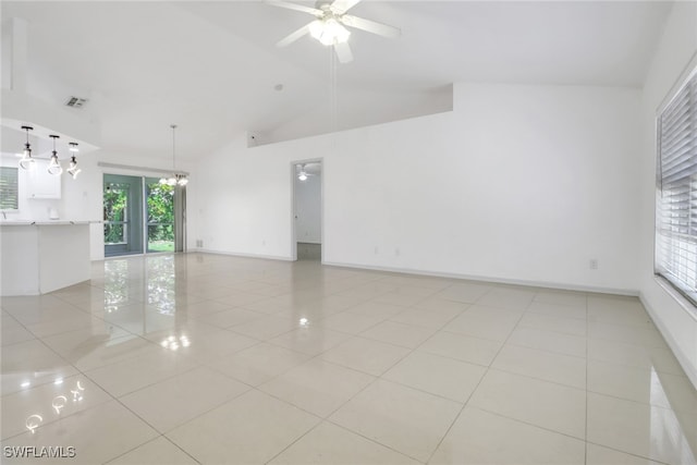 765 Aprile Ave S, Lehigh Acres, FL 33974 - spare room featuring plenty of natural light, light tile patterned flooring, a ceiling fan, and high vaulted ceiling