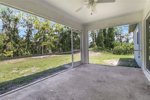 765 Aprile Ave S, Lehigh Acres, FL 33974 - unfurnished sunroom with ceiling fan and view of wooded area