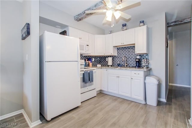 3226 Stringfellow Rd, Saint James City, FL 33956 - kitchen with white appliances, white cabinets, and backsplash