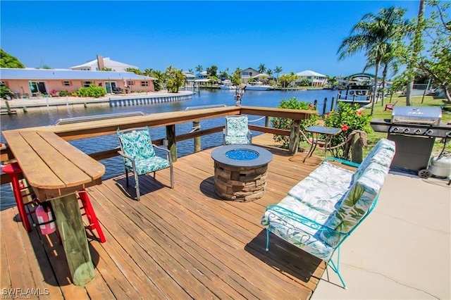 3226 Stringfellow Rd, Saint James City, FL 33956 - dock area featuring an outdoor fire pit and a deck with water view