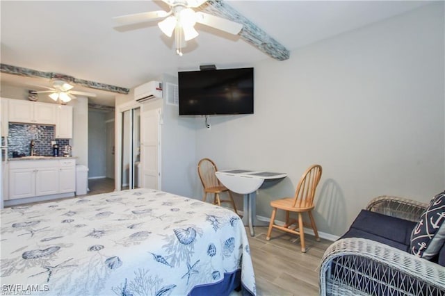 3226 Stringfellow Rd, Saint James City, FL 33956 - bedroom featuring a wall mounted air conditioner, light wood finished floors, and a ceiling fan