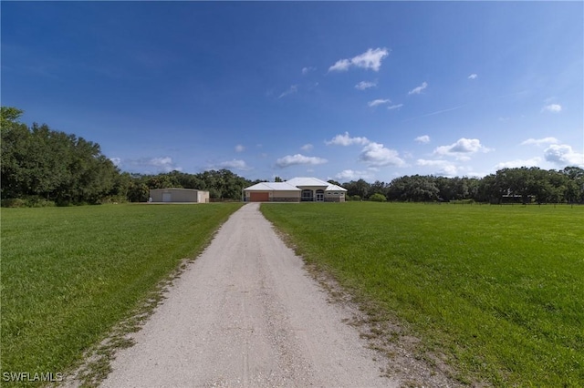 19801 N River Rd, Alva, FL 33920 - ranch-style home featuring dirt driveway, a front lawn, and a view of rural / pastoral area