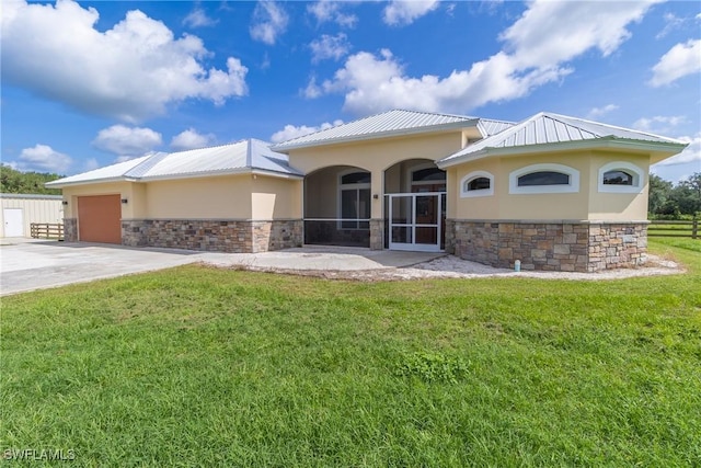 19801 N River Rd, Alva, FL 33920 - view of front of home featuring stone siding, stucco siding, an attached garage, a front lawn, and a metal roof