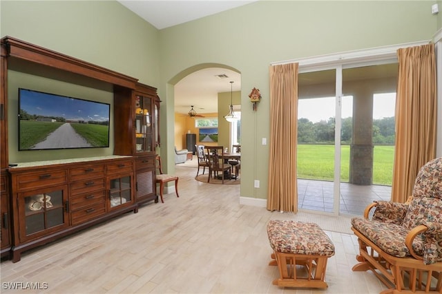 19801 N River Rd, Alva, FL 33920 - living area with arched walkways and light wood-style flooring