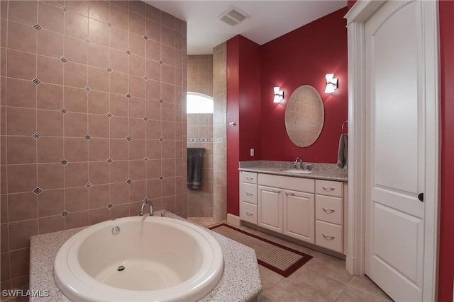 19801 N River Rd, Alva, FL 33920 - full bathroom with vanity, a garden tub, and tile patterned floors