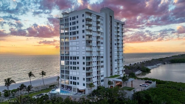 10 Seagate Dr Unit 10N, Naples, FL 34103 - property at dusk with a water view and a view of apartment building / complex
