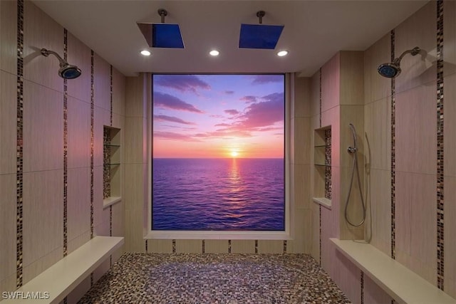 10 Seagate Dr Unit 10N, Naples, FL 34103 - bathroom featuring tiled shower, a water view, and recessed lighting