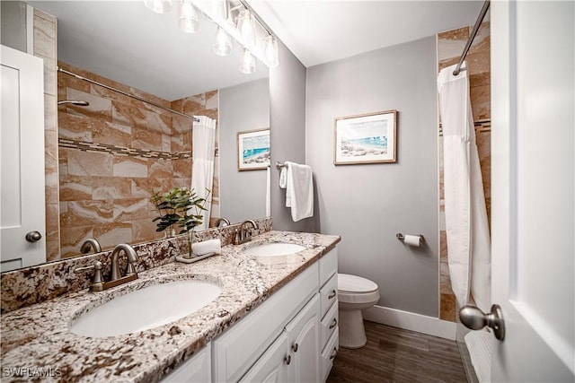 778 98th Ave N, Naples, FL 34108 - full bathroom with double vanity, wood finished floors, and tiled shower