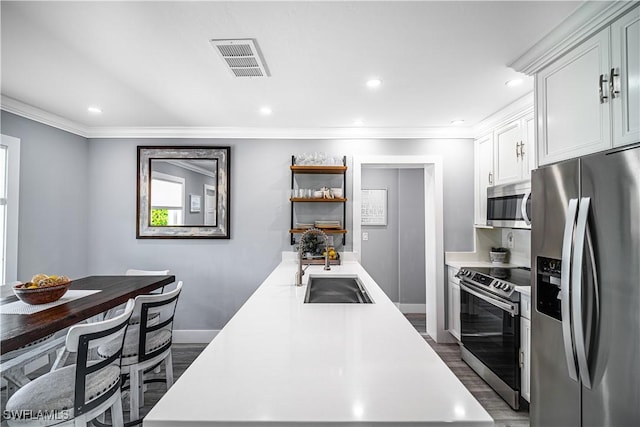 778 98th Ave N, Naples, FL 34108 - kitchen featuring appliances with stainless steel finishes, light countertops, crown molding, open shelves, and white cabinets