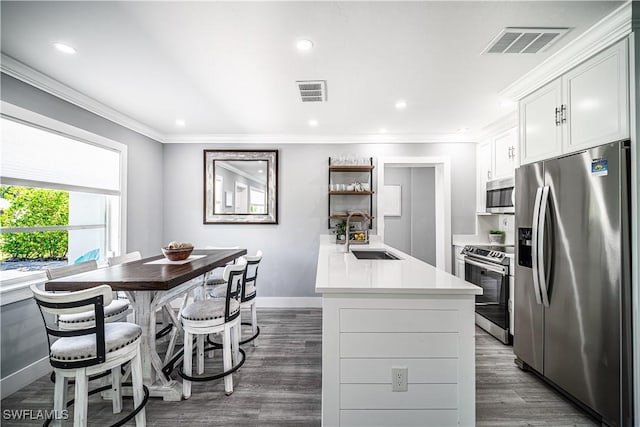 778 98th Ave N, Naples, FL 34108 - kitchen with stainless steel appliances, light countertops, dark wood-style floors, ornamental molding, and a peninsula