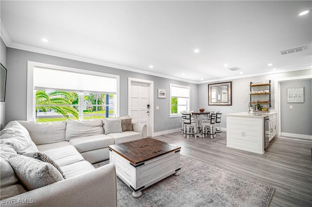 778 98th Ave N, Naples, FL 34108 - living room with crown molding, recessed lighting, light wood-style floors, and beverage cooler
