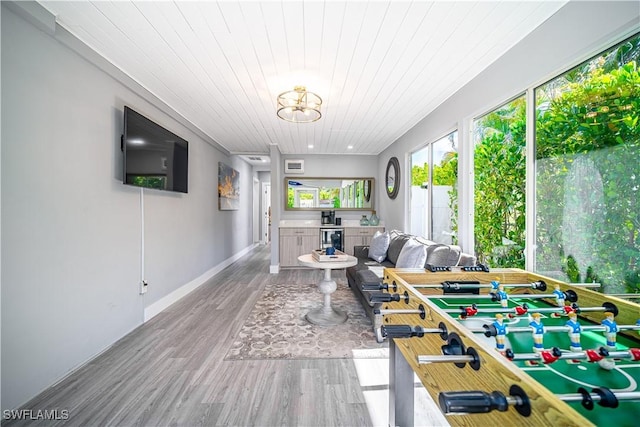 778 98th Ave N, Naples, FL 34108 - living area featuring wood finished floors, wooden ceiling, beverage cooler, and a chandelier