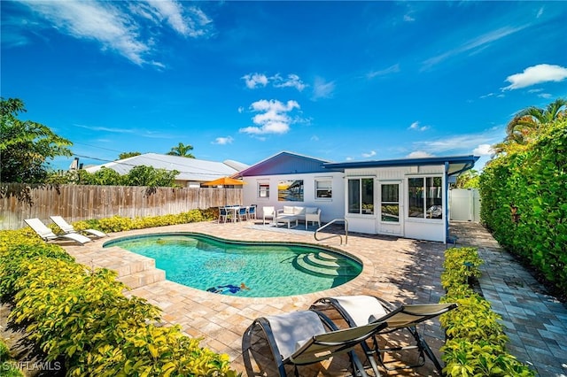 778 98th Ave N, Naples, FL 34108 - view of pool featuring a patio area, a fenced backyard, and a sunroom