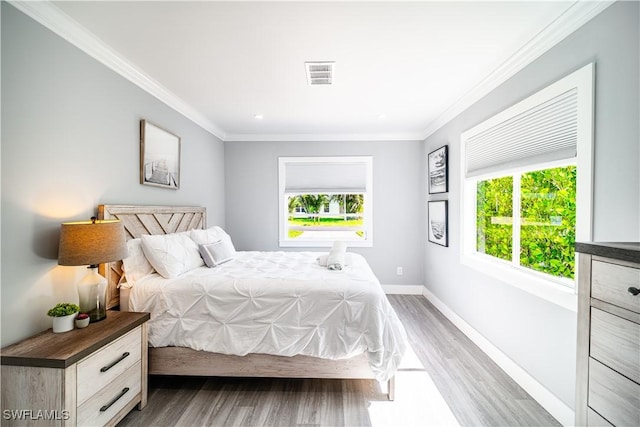 778 98th Ave N, Naples, FL 34108 - bedroom with ornamental molding and wood finished floors