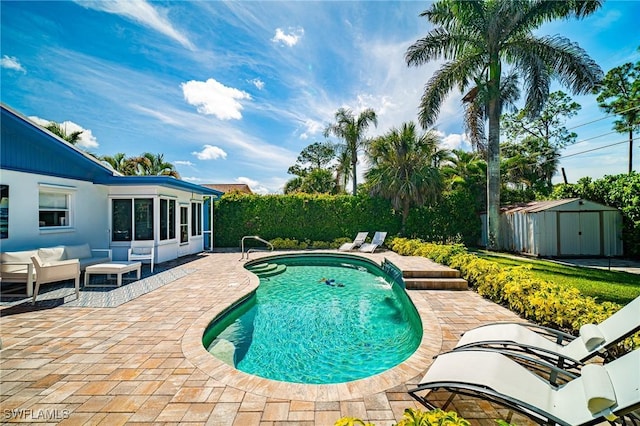 778 98th Ave N, Naples, FL 34108 - view of swimming pool featuring a patio area, a storage unit, and an outdoor hangout area