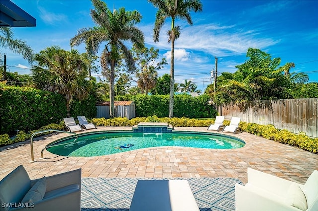 778 98th Ave N, Naples, FL 34108 - view of pool featuring a patio, a fenced backyard, and a storage shed
