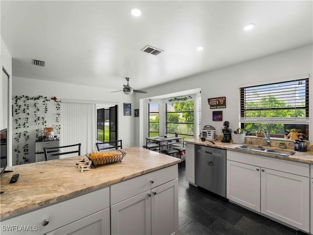 17577 Moorfield Dr, Fort Myers, FL 33908 - kitchen featuring stainless steel dishwasher, ceiling fan, light stone countertops, recessed lighting, and white cabinetry