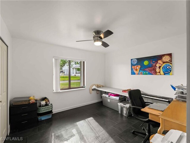 17577 Moorfield Dr, Fort Myers, FL 33908 - home office with a ceiling fan and dark tile patterned floors
