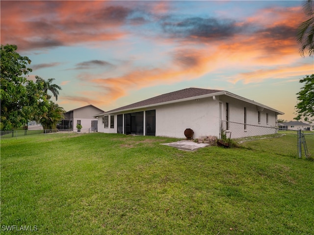 17577 Moorfield Dr, Fort Myers, FL 33908 - back of house at dusk with stucco siding and a sunroom