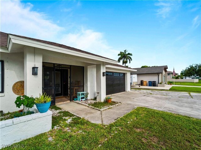 17577 Moorfield Dr, Fort Myers, FL 33908 - view of front of house featuring stucco siding, concrete driveway, a garage, and a front yard