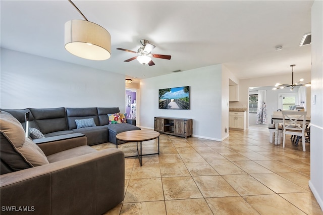 1831 SE 6th St, Cape Coral, FL 33990 - living room featuring a chandelier, a ceiling fan, and light tile patterned flooring