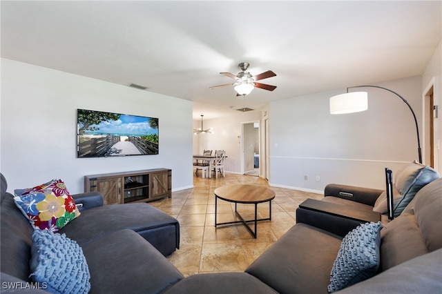 1831 SE 6th St, Cape Coral, FL 33990 - living area with light tile patterned floors, ceiling fan, and a chandelier