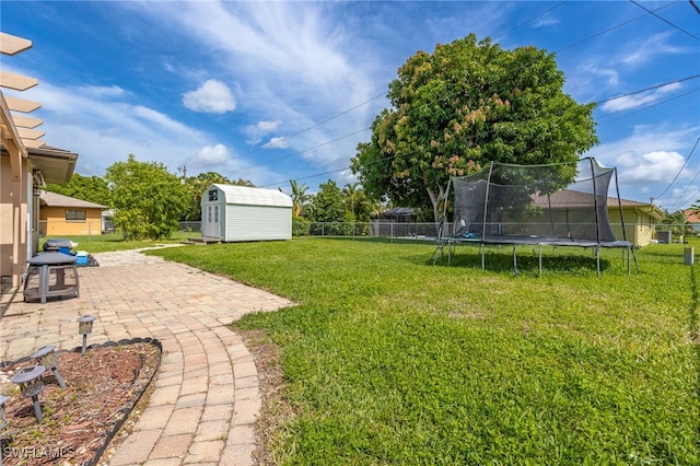 1831 SE 6th St, Cape Coral, FL 33990 - fenced backyard featuring a trampoline, a patio area, and a storage unit