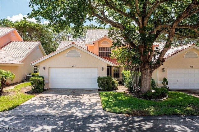 4718 Via Carmen, Naples, FL 34105 - view of front of home featuring an attached garage, stucco siding, concrete driveway, and a tiled roof