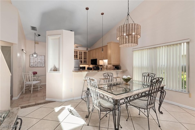 4718 Via Carmen, Naples, FL 34105 - dining space with light tile patterned floors, high vaulted ceiling, and a chandelier
